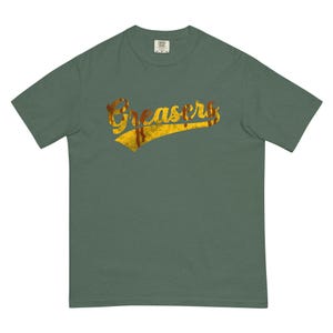 May include: A green t-shirt with a yellow and brown vintage-style graphic that says "Greasers".