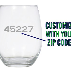 May include: A clear glass wine glass with the number 45227 etched on the side. The text "CUSTOMIZE WITH YOUR ZIP CODE!" is written in green and blue text on the right side of the image.