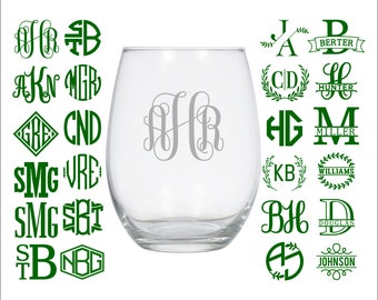 May include: A clear glass wine glass with a silver monogram of the letters "JHR" on the front. The image also shows a variety of green monogram designs with different letters and names, such as "Hunter", "Miller", "Williams", and "Johnson".
