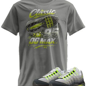 May include: Gray t-shirt with a graphic of a sneaker sole, the text "Classic 95 OG MAX", and a pair of matching sneakers. The sneakers are gray, white, and neon yellow.