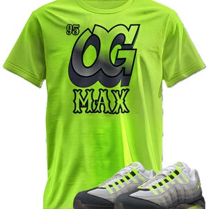 May include: A neon green t-shirt with the text "OG MAX" in black and gray, paired with matching sneakers. The sneakers are gray, white, and neon green. The shirt also has the number "95" on it.