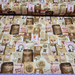 May include: A brown and white fabric with a repeating pattern of coffee bags and coffee-related text. The text includes "Good Pot Coffee", "Brew Team New", "Old Fashioned Deja Brew", "Dream Bean Coffee", "No Doze", "Hard Wired", "Steam Room", "Ancient Sip", "Daddy's Grind", "Perkatory Brew", "Get A Drip", "It's A Grind", "Black Gold", "Cuban French Kiss Coffee", "Doughnut Shop", and more.