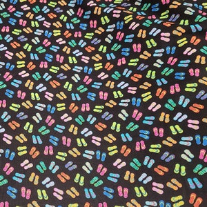 May include: Black fabric with a repeating pattern of colorful flip flops. The flip flops are in various colors, including pink, blue, green, yellow, and orange.