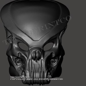 Puede incluir: Una máscara de Depredador gris oscuro con un diseño detallado y texturizado. La máscara presenta aberturas para los ojos, una ceja prominente y detalles faciales intrincados. El texto "TECNOPRINTCO COPYRIGHT 2023 ALL RIGHTS RESERVED" es visible.
