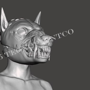 May include: A grey, three-dimensional digital render of a canine-inspired mask featuring pointed ears, a snout, and exposed sharp teeth. The text "&copy;2025 TECONTCO" is visible across the side of the mask. The design is presented on a plain background.