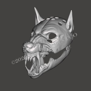 May include: A gray, three-dimensional digital render of a wolf mask featuring pointed ears, a snout with bared teeth, and a series of circular perforations along the top. The design includes a hinged jaw structure and visible eye openings.