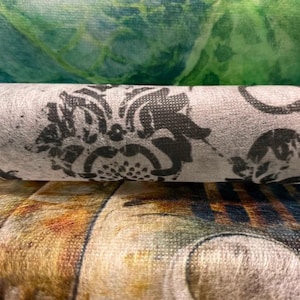 Puede incluir: Primer plano de tres rollos de papel de seda decorativo para decoupage. El rollo superior tiene un dise&ntilde;o de acuarela verde y azul. El rollo del medio tiene un fondo gris con un estampado floral negro. El papel mide 48 cm x 76 cm.