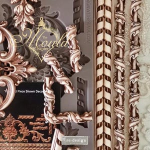 May include: An assortment of decorative moulds and embellishments in brown and cream hues. The image showcases ornate floral and scroll designs, alongside textured border elements. The moulds are likely for crafting or decorative use, with the "re-design" logo visible.