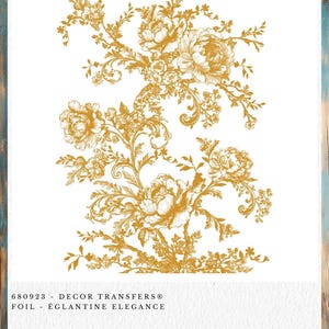 May include: A gold foil decor transfer with a floral design. The transfer features detailed illustrations of peonies and other flowers with ornate, swirling leaves and stems. The text at the bottom reads "680923 - DECOR TRANSFERS® FOIL - ÉGLANTINE ELEGANCE."