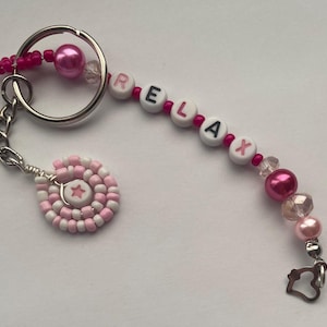 Silver Plated Handmade Pink 'RELAX' Themed Keyring.