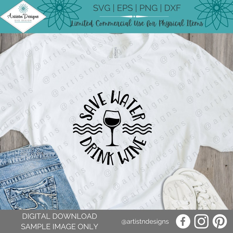 May include: A white t-shirt with a black circle design that says "Save Water Drink Wine" with a wine glass graphic inside the circle. The design is on a white t-shirt with a pair of white sneakers and blue jeans in the background.