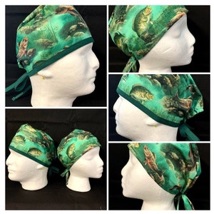 May include: A green surgical scrub hat with a print of fish and water. The hat has a green trim and ties at the back.