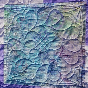 Long-arm quilting services for your pieced quilt tops. Quilt finishing, batting, backing, binding available.