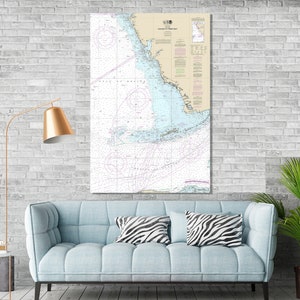 May include: A nautical chart of the Florida Keys, from Key West to Tarpon Bay, printed on a white background with blue, pink, and purple lines. The chart includes a legend and compass rose.