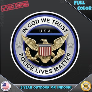 May include: A blue and silver circle sticker with the text "In God We Trust" and "Police Lives Matter" around a bald eagle with a shield that says "U.S.A."