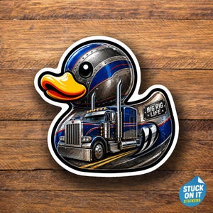 May include: A die-cut sticker featuring a stylized rubber duck with a metallic blue and silver finish, integrated with a semi-truck design. The graphic includes a yellow beak, large black eyes, and the text BIG RIG LIFE on a rectangular plate.