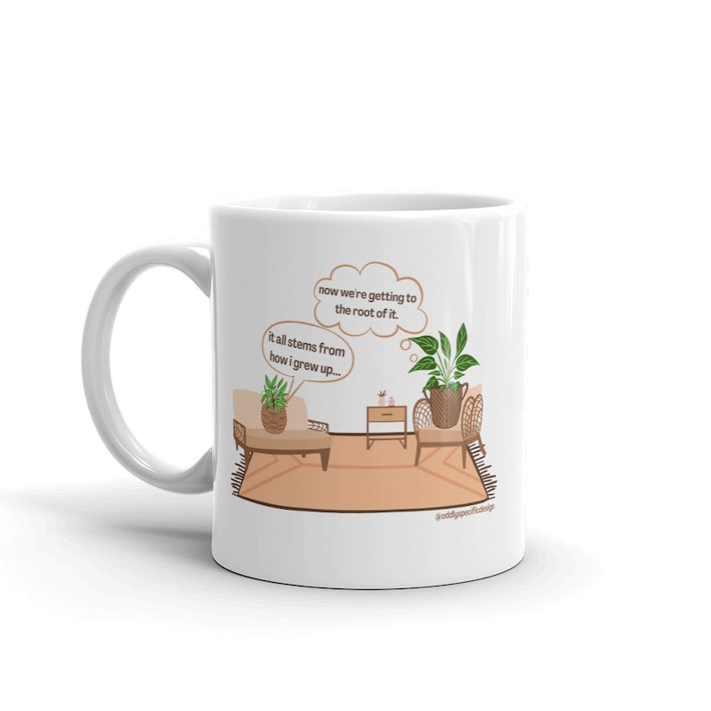 May include: White ceramic mug with a cartoon illustration of two potted plants in a room. The text on the mug reads "now we're getting to the root of it. it all stems from how i grew up..." and "@oddlyspecificthings".