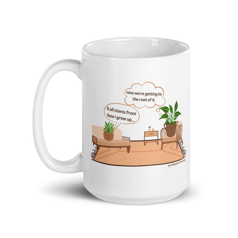 May include: White ceramic mug with a cartoon illustration of two potted plants in a living room setting. The text on the mug reads "now we're getting to the root of it. it all stems from how i grew up..." #oddlyspecific