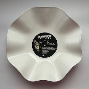 May include: A white vinyl record bowl with a scalloped edge. The center label is black with white text reading Ice Cube, It Was A Good Day, Side 1, and track listings. The label features a portrait of a person and the Priority Records logo.