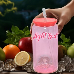 May include: A pink reusable tumbler with a red lid and a clear straw. The tumbler has the words "Light Red" printed on the side. The tumbler is surrounded by fruit and ice cubes.