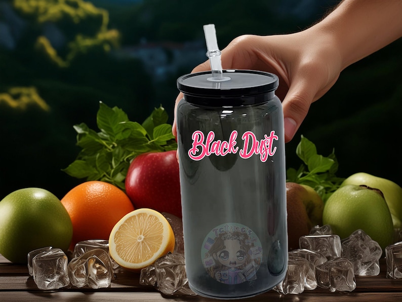 May include: A black reusable water bottle with a black lid and a clear straw. The bottle has the words "Black Dust" printed on it in pink letters. The bottle is surrounded by fruit and ice cubes.