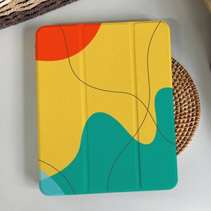 May include: A yellow, green, and red abstract design iPad case with a black outline.