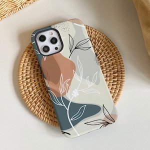 May include: A phone case with a white and blue abstract design featuring a floral pattern. The case has a camera cutout and a white background.