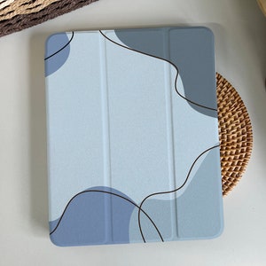 May include: A blue and grey tablet case with an abstract design featuring black lines and organic shapes.