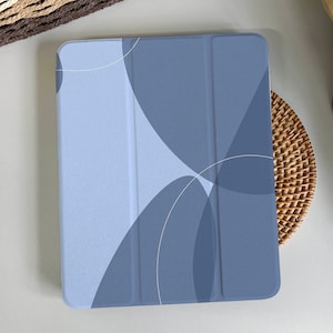 May include: A blue and white geometric pattern iPad case with a three-piece design.