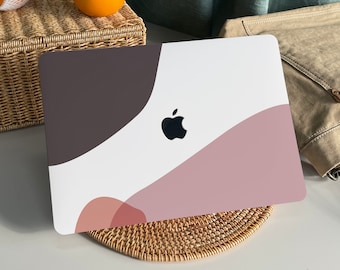 May include: A white laptop with a geometric abstract design in shades of brown, pink, and red. The laptop has a black Apple logo.