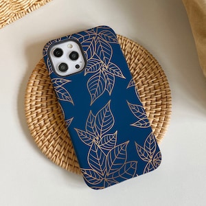 May include: A blue phone case with a gold leaf pattern. The case is designed for an iPhone.