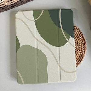 May include: A green and beige abstract design iPad case with a geometric pattern. The case is made of a durable material and has a sleek, modern look.