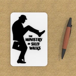 May include: A black and white silhouette of a man in a bowler hat and suit walking with a briefcase. The text "THE MINISTRY OF SILLY WALKS" is below the silhouette.