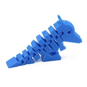 May include: A blue plastic articulated dinosaur toy. The dinosaur is in a standing position with its tail curled up.
