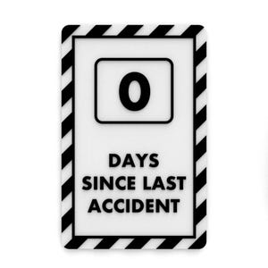Puede incluir: Un cartel en blanco y negro con un borde rayado. El cartel dice "0 DÍAS DESDE EL ÚLTIMO ACCIDENTE".
