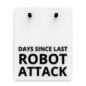 Könnte beinhalten: Weißes rechteckiges Schild mit dem Text "DAYS SINCE LAST ROBOT ATTACK" in fetten schwarzen Buchstaben. Oben befinden sich zwei schwarze Stifte. Das Schild ist eine humorvolle Variante eines Countdowns.