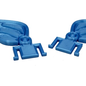 May include: Two blue plastic wings with a textured surface and a small, square base. The wings are designed to be attached to a larger object.