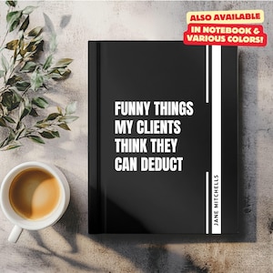 Puede incluir: Diario negro con texto blanco que dice "Funny things my clients think they can deduct." El nombre del autor, "Jane Mitchells", está impreso en el lomo. El diario está sobre una superficie marrón claro con una planta verde en el fondo.