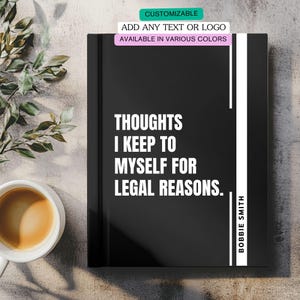 May include: A black notebook with the text "THOUGHTS I KEEP TO MYSELF FOR LEGAL REASONS." and the name "BOBBIE SMITH" in white. The notebook has a white vertical stripe and is on a light-colored surface. Text at the top says "CUSTOMIZABLE".