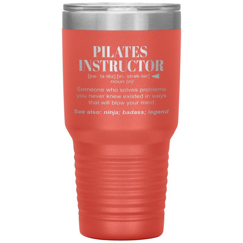 May include: A red and silver stainless steel tumbler with the text "PILATES INSTRUCTOR" and a definition of the word. The text is in white and the background is a bright red.