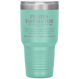 May include: A teal stainless steel tumbler with a silver lid. The tumbler has a definition of "Pilates Instructor" engraved on the side. The definition reads: "[pe-la-tēz] [in-'strek-ter] noun (n) Someone who solves problems you never knew existed in ways that will blow your mind; See also: ninja; badass; legend"