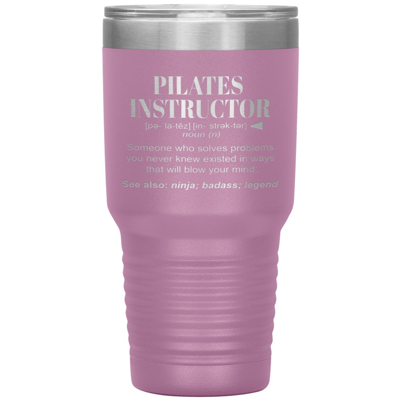 May include: A pink stainless steel tumbler with a silver lid. The tumbler has a definition of "Pilates Instructor" with the phonetic pronunciation and a description of the role.