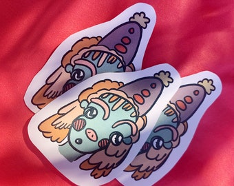 May include: Three stickers featuring a whimsical cartoon character with a teal face, brown hair, and a purple hat. The stickers are on a red background. The character has a unique design with a playful expression.