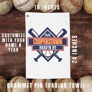 May include: White baseball trading towel, 16 x 24 inches, with a grommet. Features a baseball bat and ball design with "COOPERSTOWN" and "BRADYN #9" text. Includes space to customize with name and year.