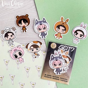 May include: A set of nine cartoon stickers featuring members of the K-pop group GOT7. Each sticker features a different member wearing an animal costume. The stickers are printed on white paper and have a glossy finish.
