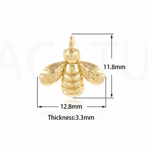 May include: Gold-toned bee charm pendant with a detailed design. The charm measures 1.18 inches in height and 1.28 inches in width. The thickness is 0.33 inches.