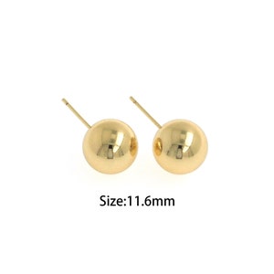 May include: A pair of gold-colored ball stud earrings. The earrings are 11.6mm in size.