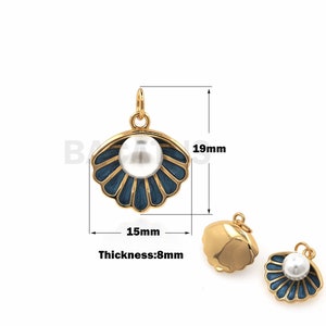 May include: Gold-tone seashell pendant with a white pearl center and navy blue enamel accents. The pendant measures 19mm high, 15mm wide, and 8mm thick. Additional gold-tone seashell pendant shown.