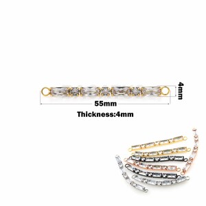 May include: Gold-tone chain with clear rectangular crystals, measuring 55mm in length and 4mm in thickness. The chain has two loops at the ends.