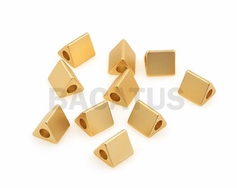 May include: A group of ten gold-colored triangle-shaped beads with a hole in the center of each bead.